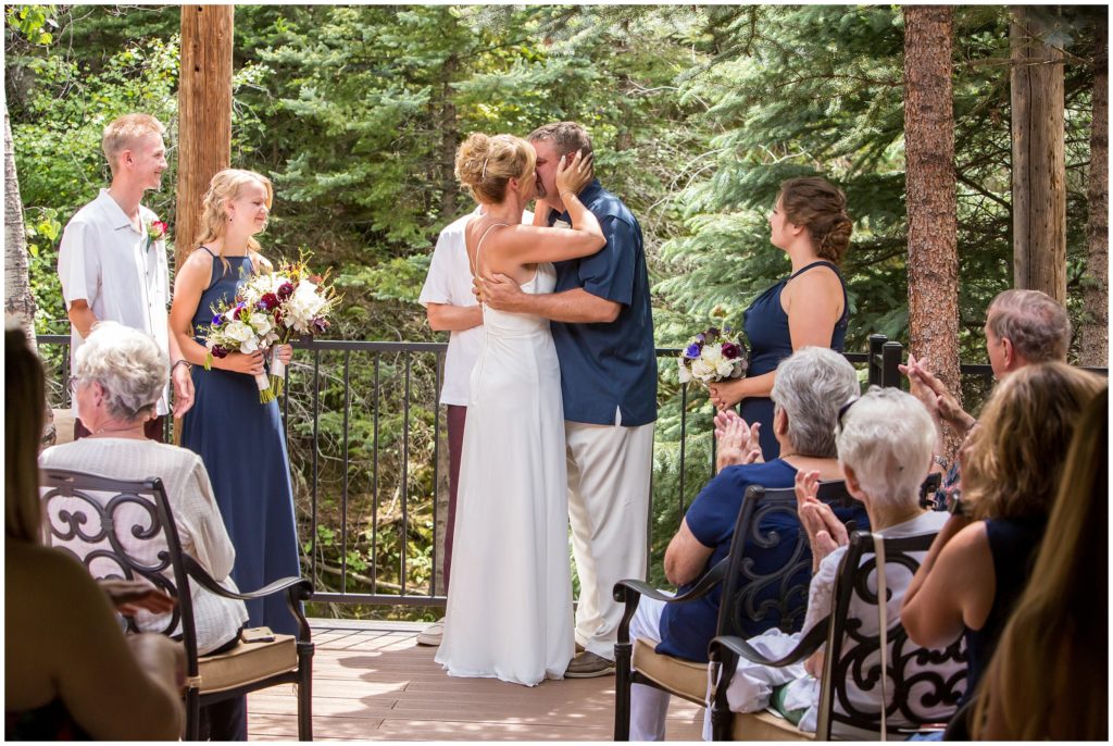 First kiss during this mountain wedding in Glenhaven, Colorado