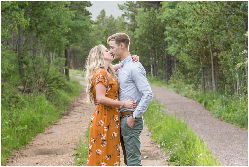 kissing in the rain in Rocky Mountain National Park - CO engagement photography