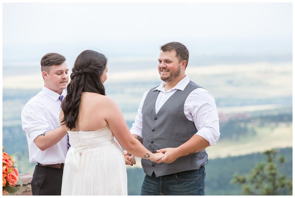Saying vows during their wedding at the Sunrise Amphitheater in Boulder Colorado