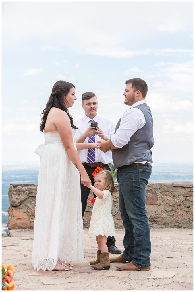 Ring exchange during this Boulder Wedding at Sunrise Amphitheater