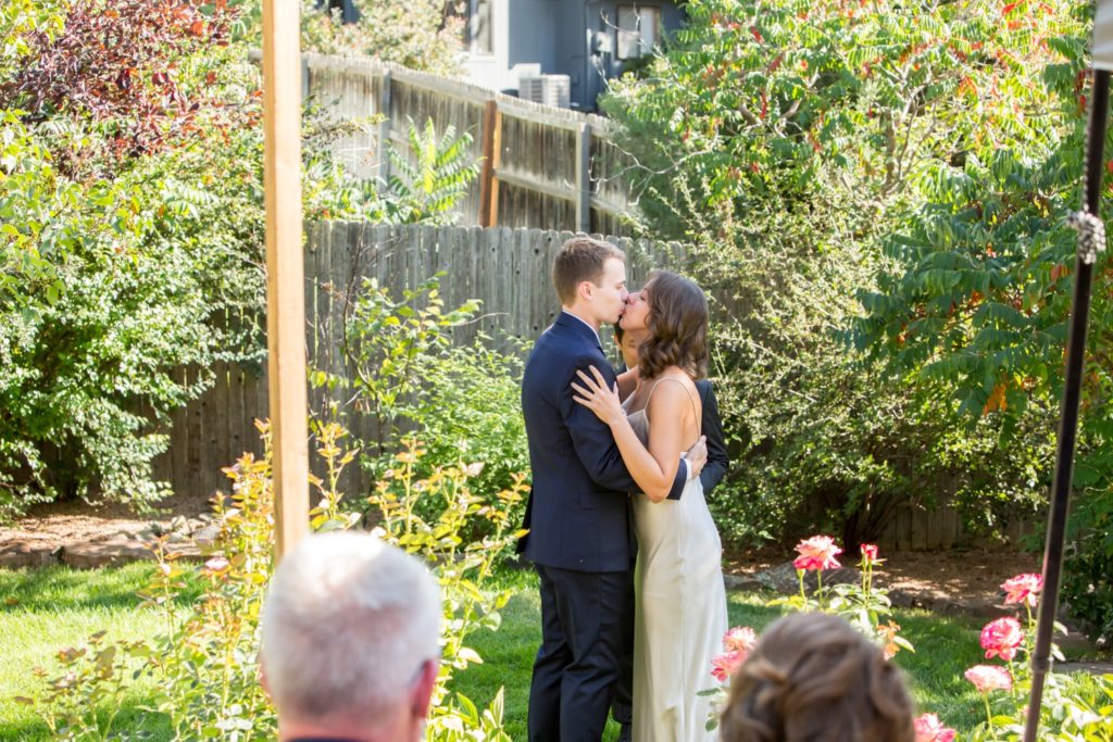 First kiss wedding ceremony in Colorado backyard