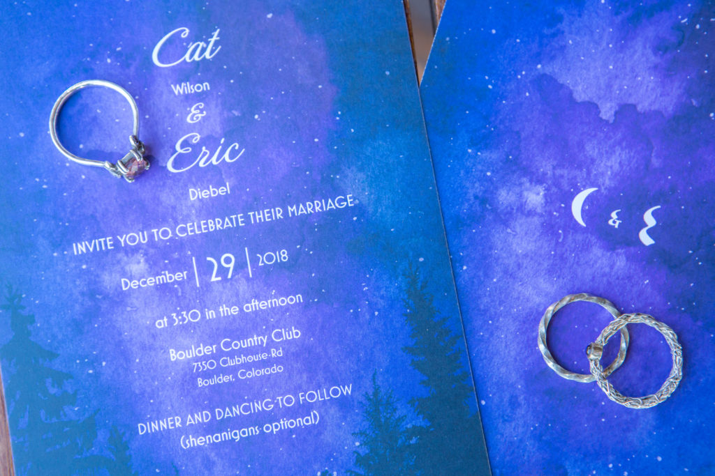 Ring and invitation details during a Boulder Country Club wedding