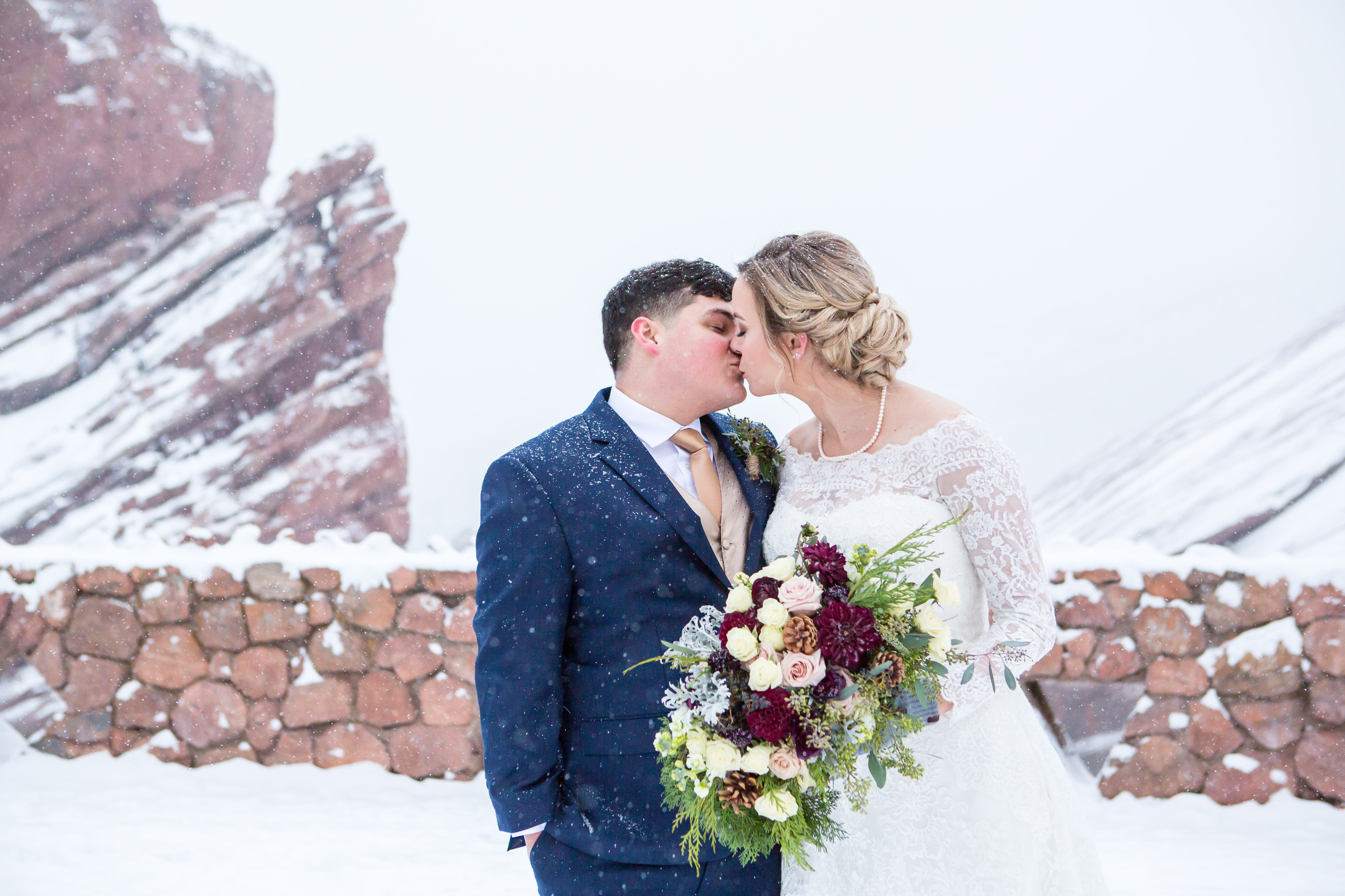romantic wedding portrait of couple kissing in the snow - Nichole Emerson Photography