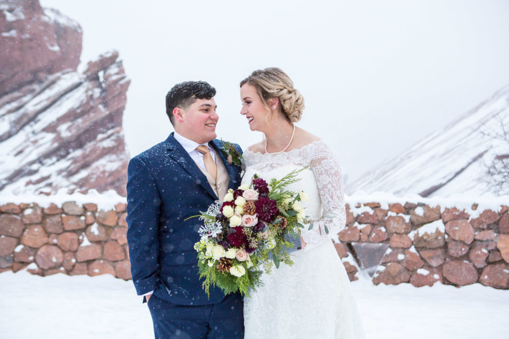 couple portrait laughing in the snow at Red Rocks Park - - Nichole Emerson Photography