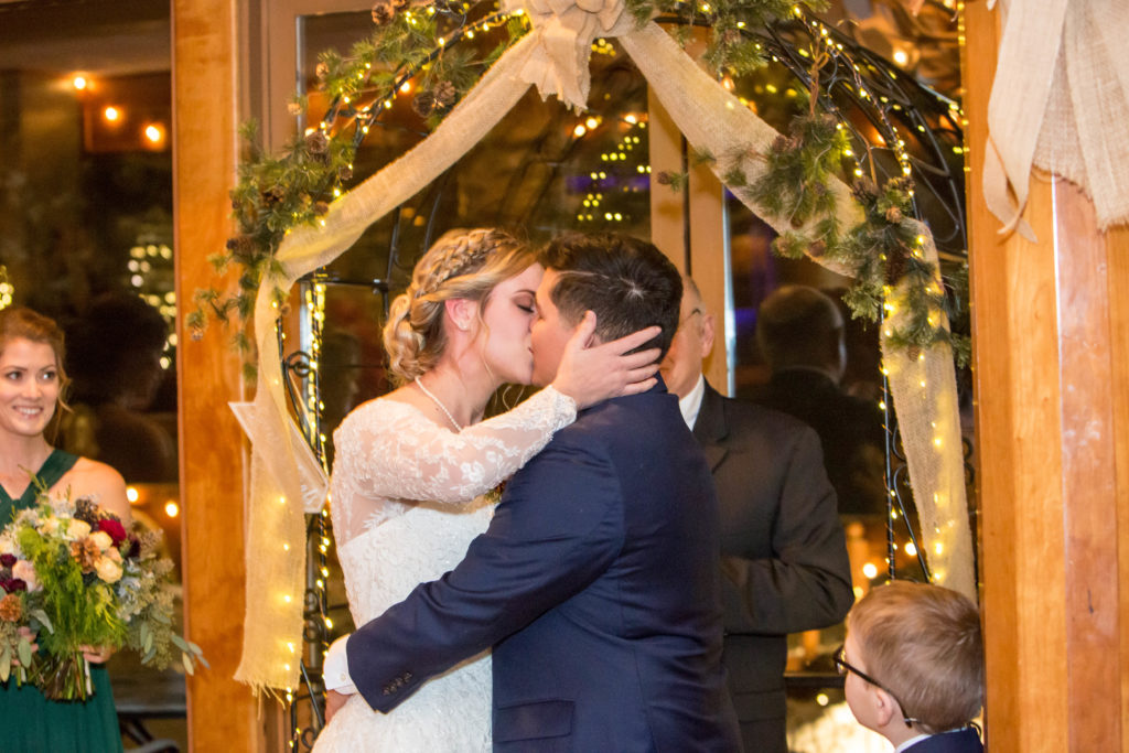 couple kissing during the ceremony - - Nichole Emerson Photography