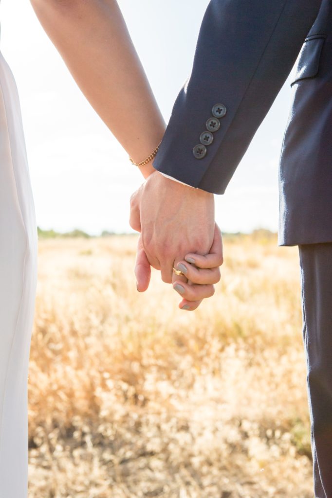 bride and groom hands and wedding ring in Colorado