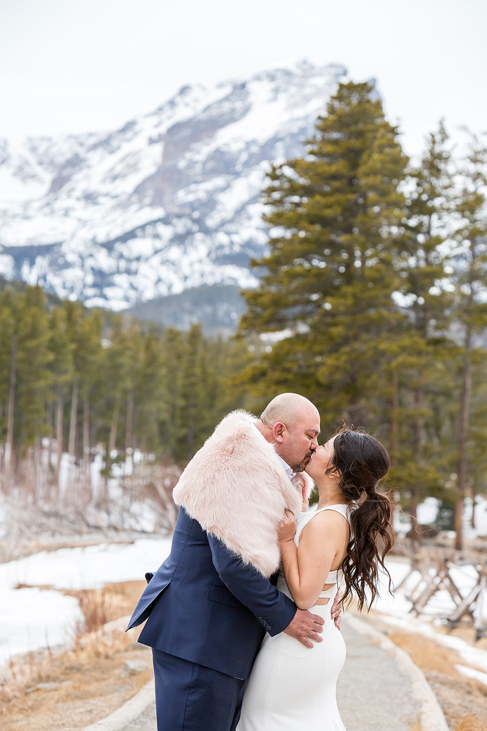 Wendy pulls Micheal in for a kiss with her shawl at Sprague Lake