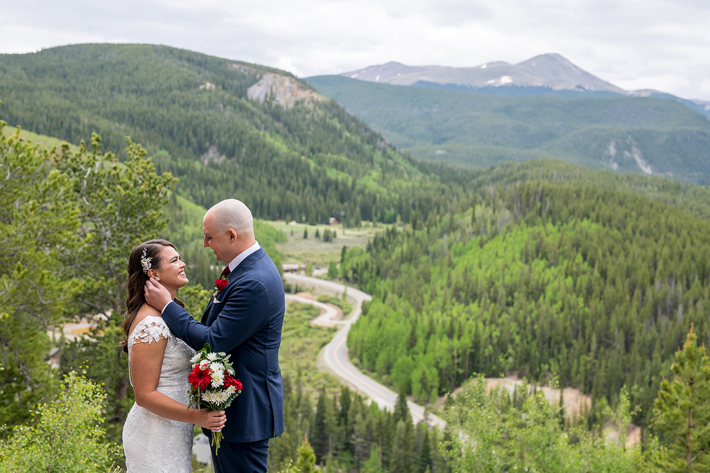 Kayla smiling in her wedding dress at Nathan in Breckenridge, CO.