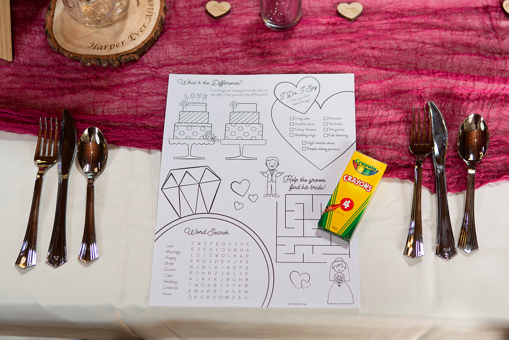 Close up of wedding kids table activity sheet with crayons.