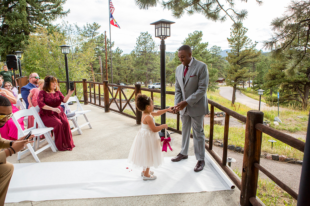 Flower girl gives rings to the groom at Chief Hosa Lodge.