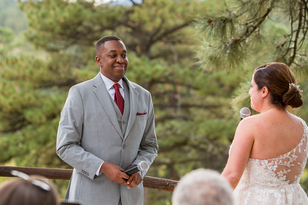 Groom smiles during vows in Evegreen, CO.