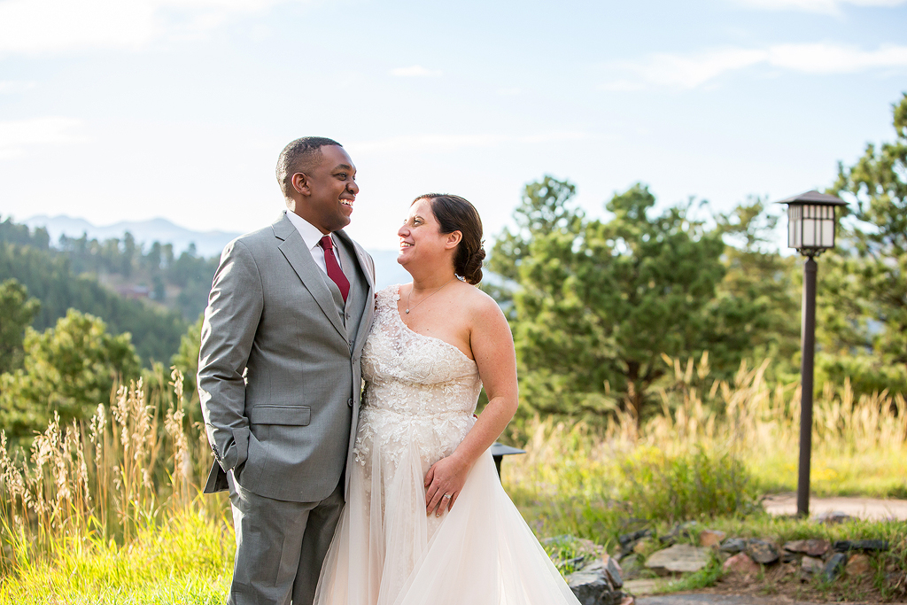 Nashion and Kelly laugh in front of a mountain view.