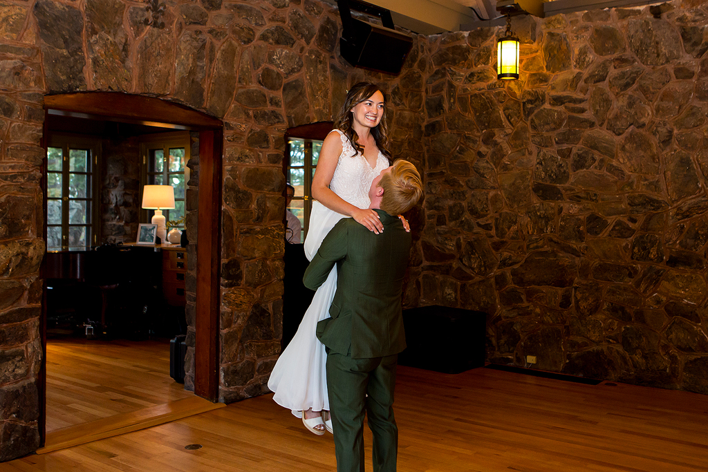 Bride is lifted in the air during their first dance at Boettcher Mansion.