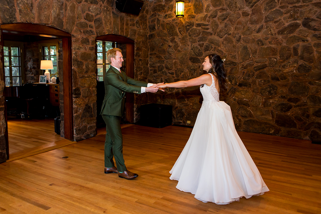 Couple swings out from each other during their first dance.