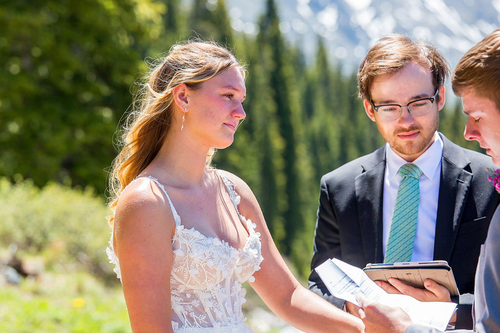 Madi smiles softly as Chase says his vows during the elopement ceremony