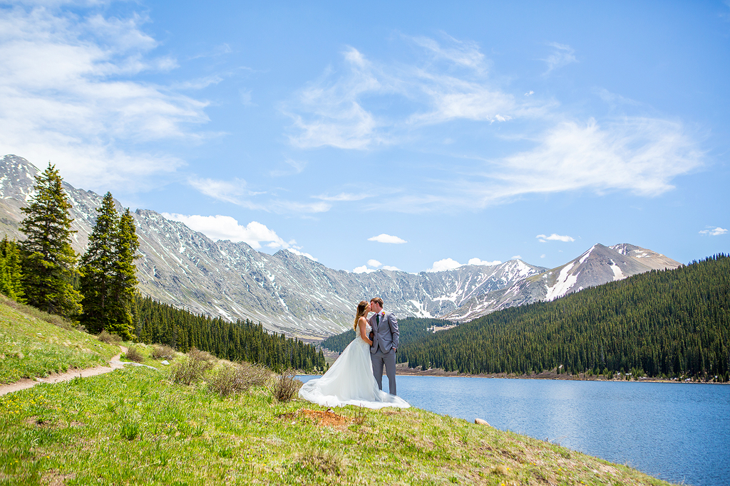 wide view of Clinton Gulch Dam Reservoir with bride and groom standing near the beach.
