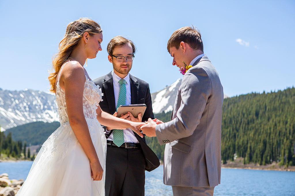 Chase puts on Madi's wedding ring at an alpine lake.
