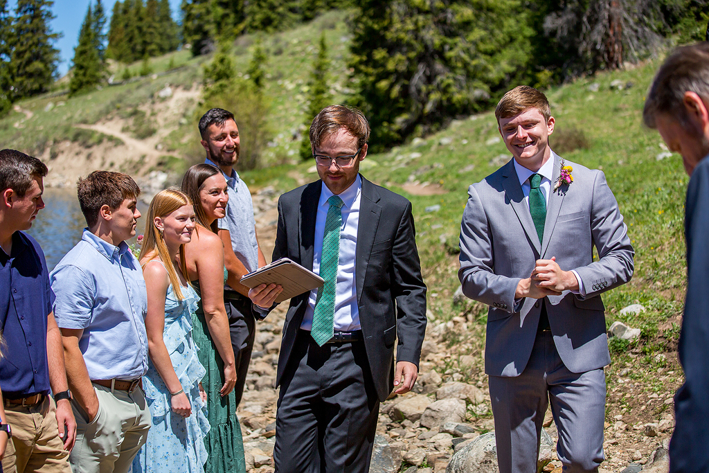 groom walks down the beach to start their elopement ceremony in Colorado.