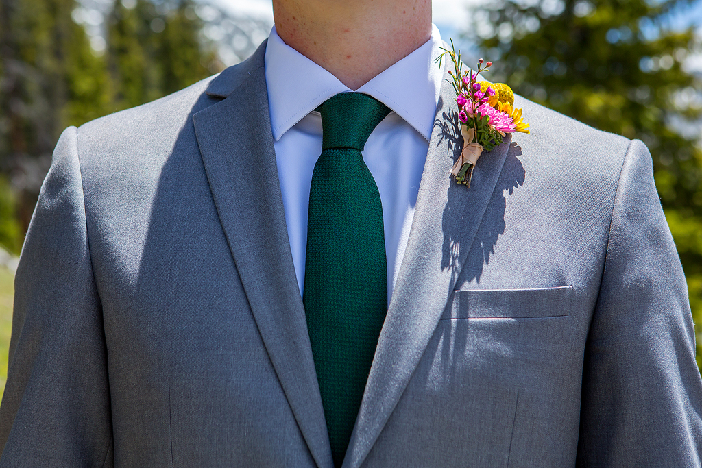 Close up of suit, tie, and boutonniere