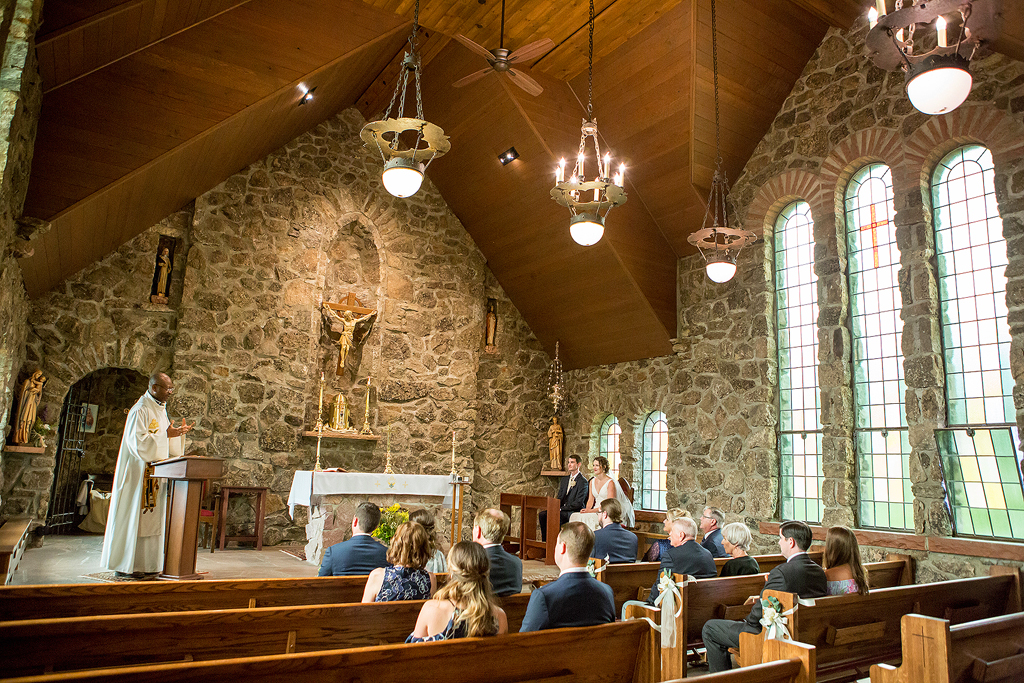 Priest addresses guest and wedding couple during the ceremony in Colorado