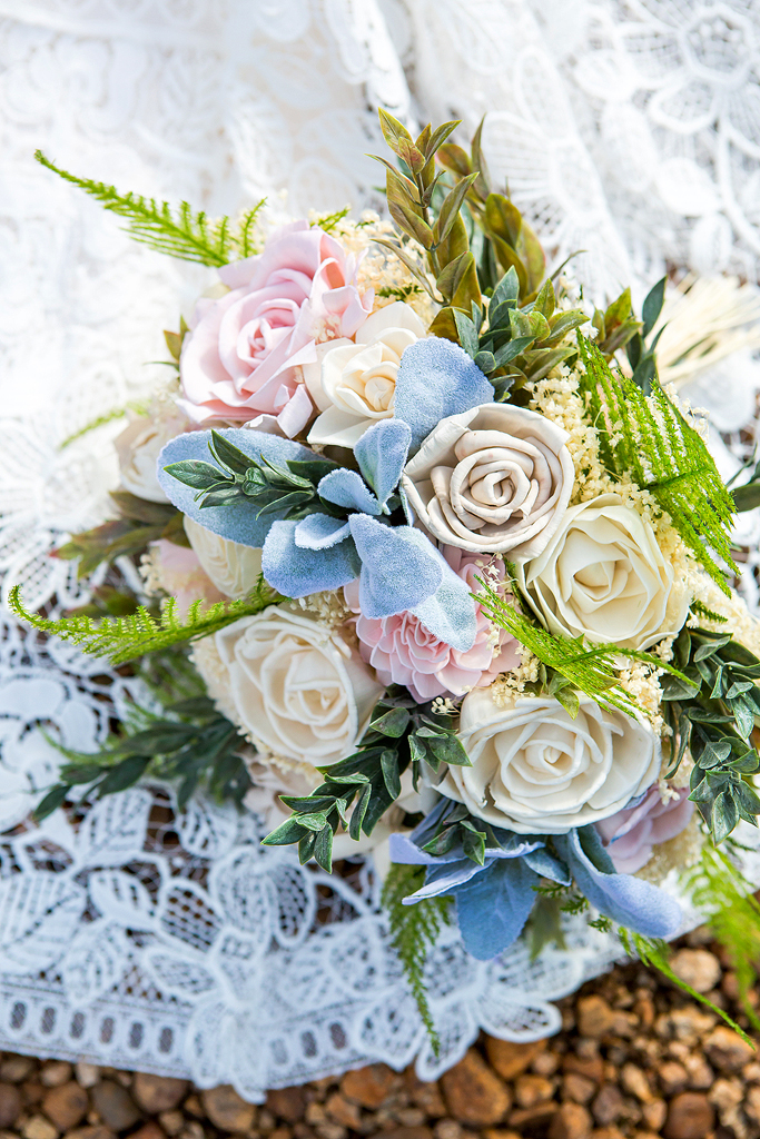 Close up of bridal bouquet and wedding dress lace