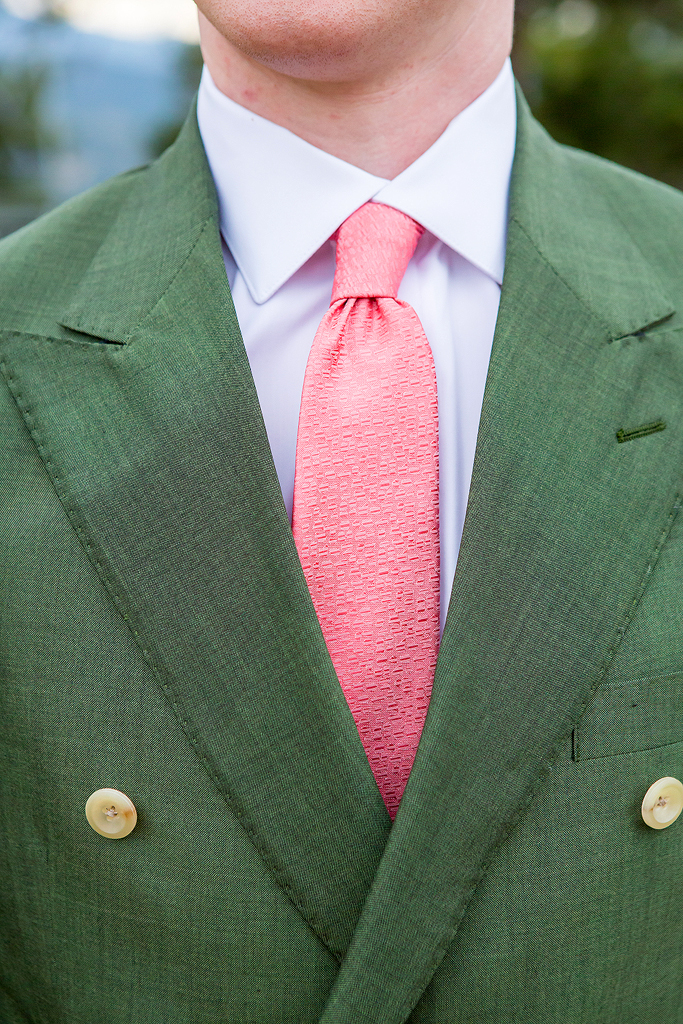Close up of groom's green suite with tie.