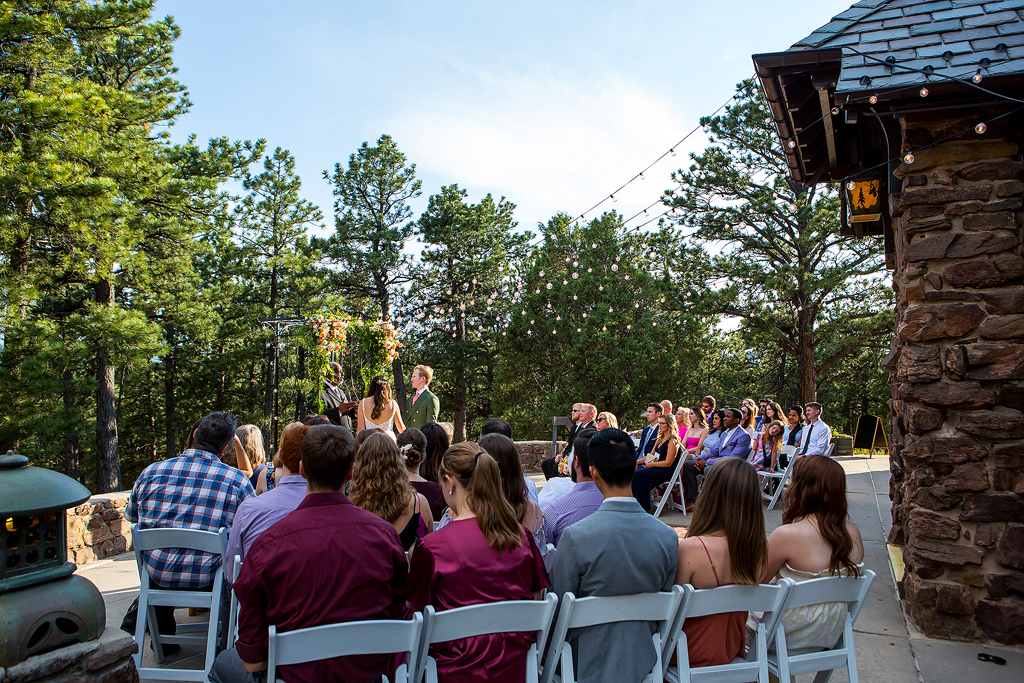Wide view of Boettcher Mansion wedding ceremony with guests in Golden, CO.