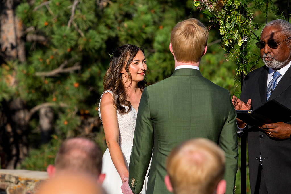 Bride smiles during wedding ceremony in Golden, Colorado.