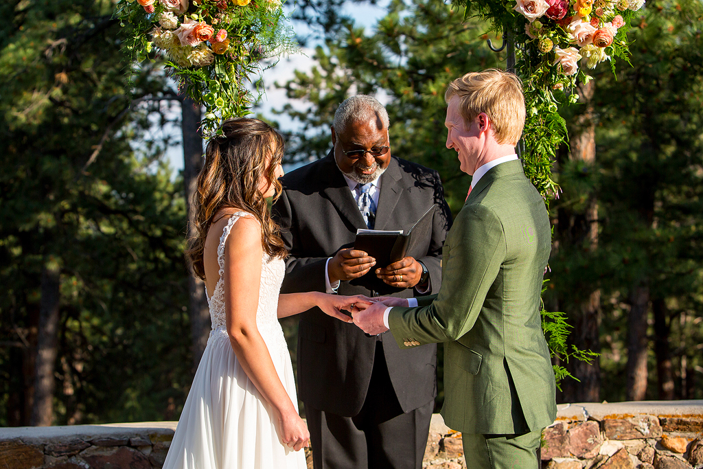 Bride and groom exchange rings at Boettcher Mansion