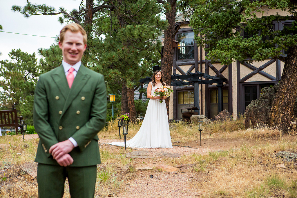 Bride walks over to groom with the Boettcher Mansion building in the background.