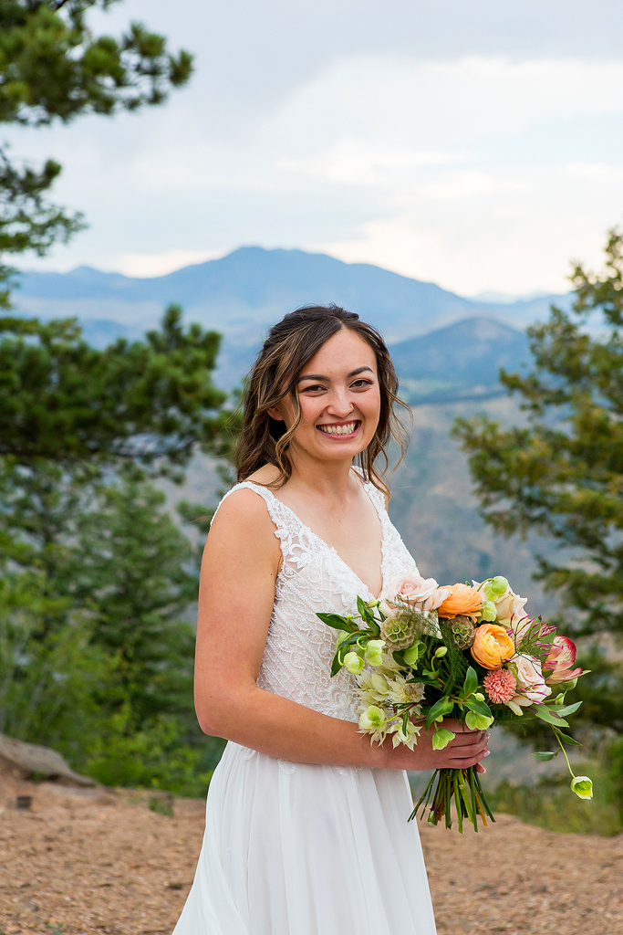 Bride holds her bouquet in front of the mountains in Golden, Colorado.