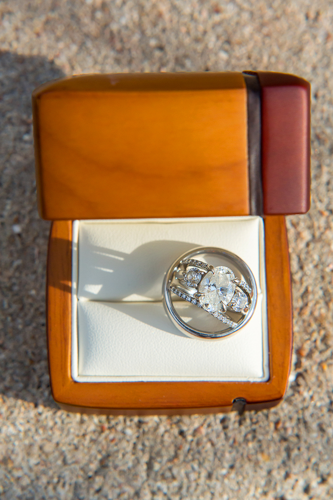 Close up of wedding rings in a tan ring box.