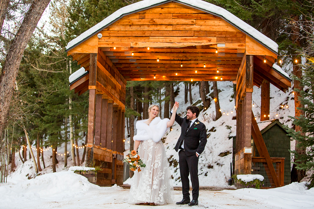 bride and groom dance near the creek Bridge during this Blackstone Rivers Ranch wedding in Colorado.