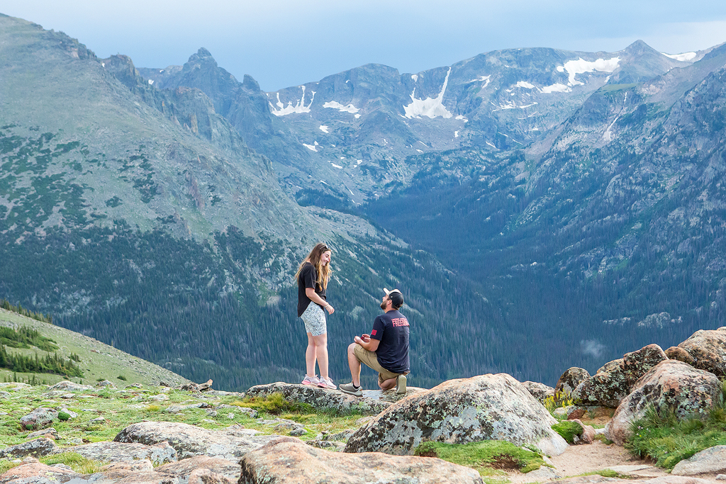 Zach kneels to propose on the Ute Trail along Trail Ridge Road.