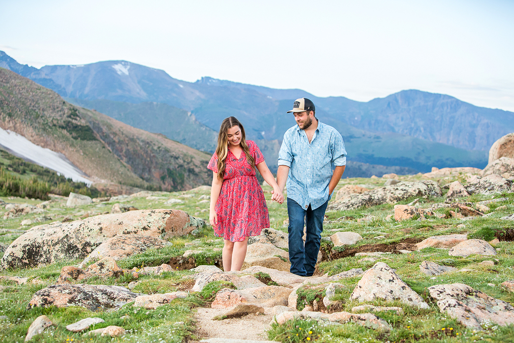 Zach and Sabrina walking along a dirt path near Trail Ridge Road after their proposal.