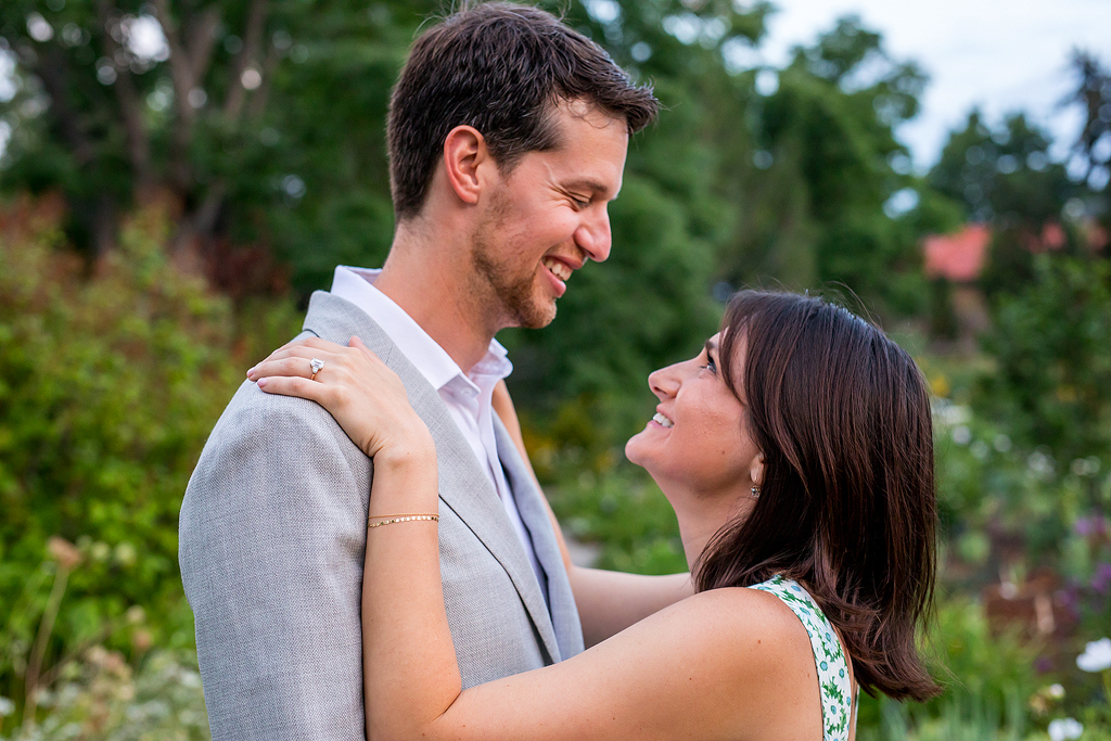 Couple in front of colorful green plants at Denver Botanic Gardens during their engagement.