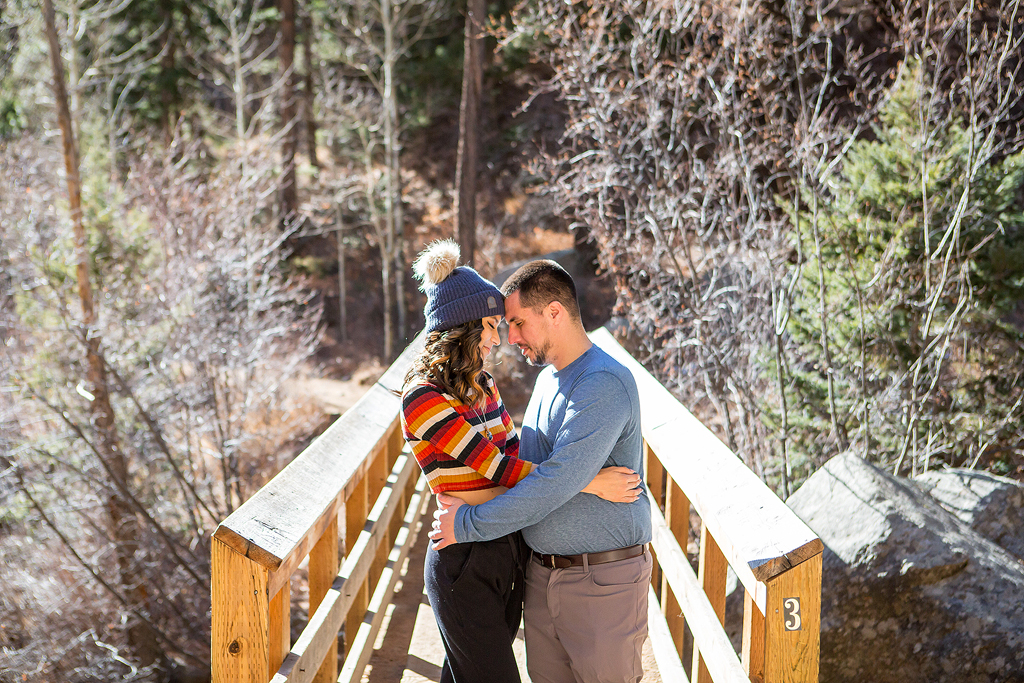 Carlos and Juliana embrace on bridge #3 along the 7 Bridges trail where he proposed in Colorado.