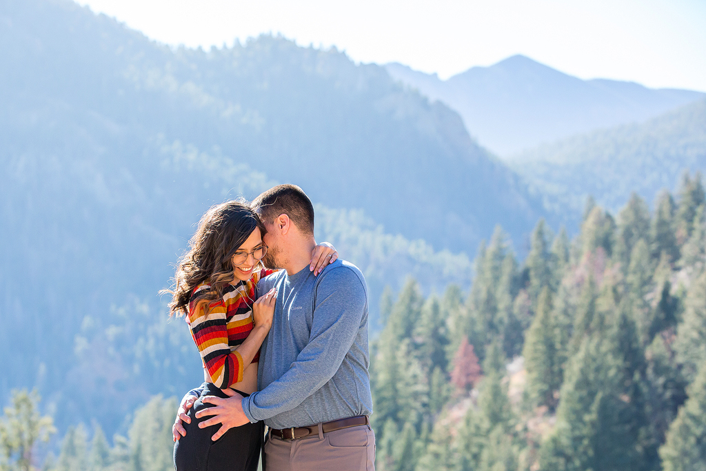 Carlos and Juliana in front of a mountain view during their engagement near Colorado Springs.