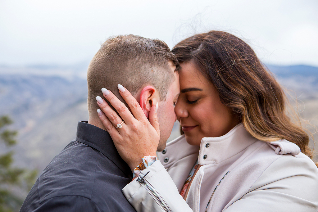 Close-up of Marissa's engagement ring with Colorado mountains in the background.