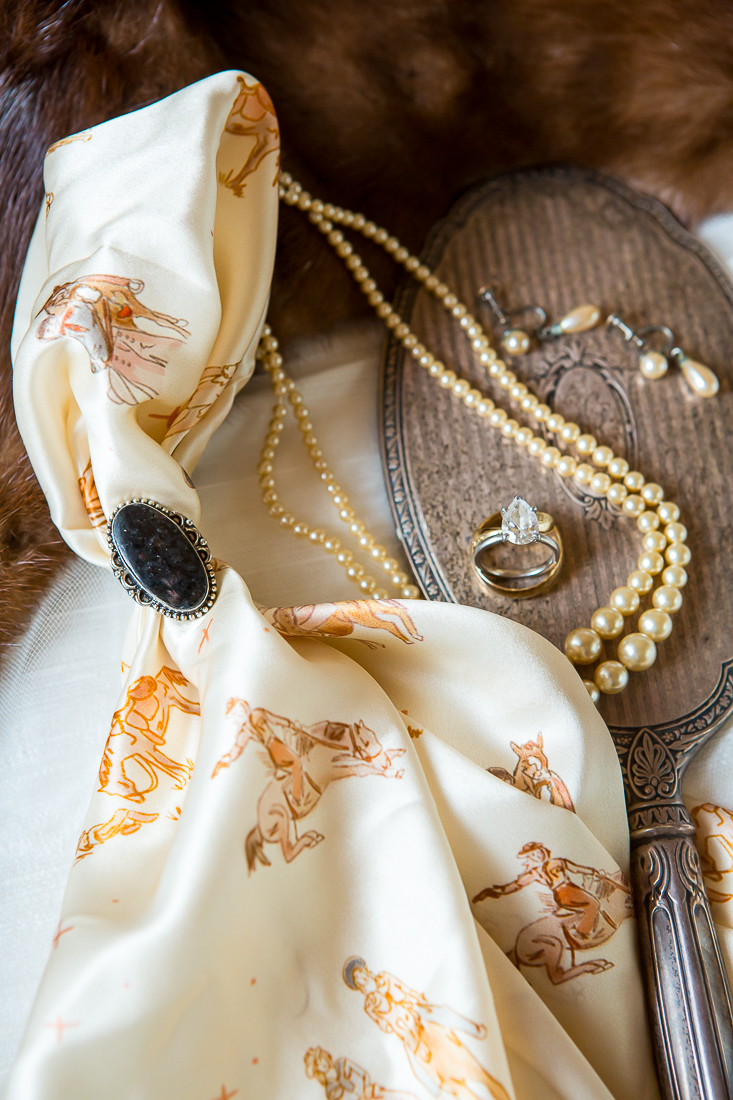 Detail shot of wedding rings and bride's accessories.