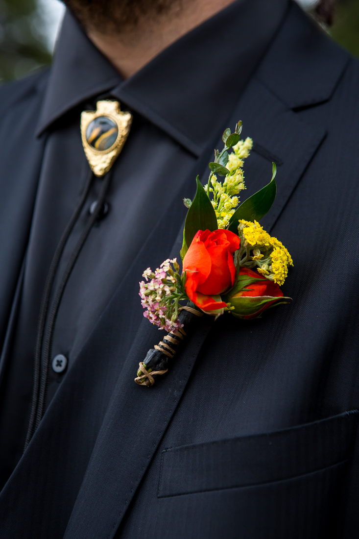 Close up of groom's boutonniere and tie for a Colorado elopement in the mountains of Gunnison.