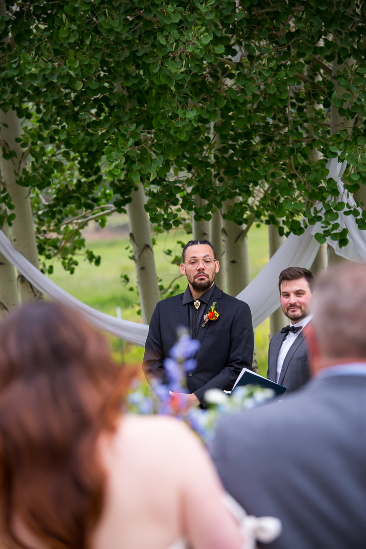 Close up of groom's reaction as he sees the bride for the first time.