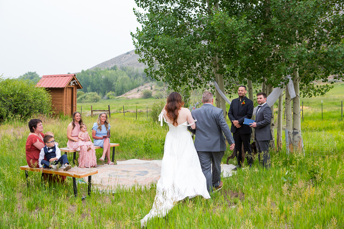 Groom's face as bride walks down the aisle during a Colorado elopement in Gunnison.
