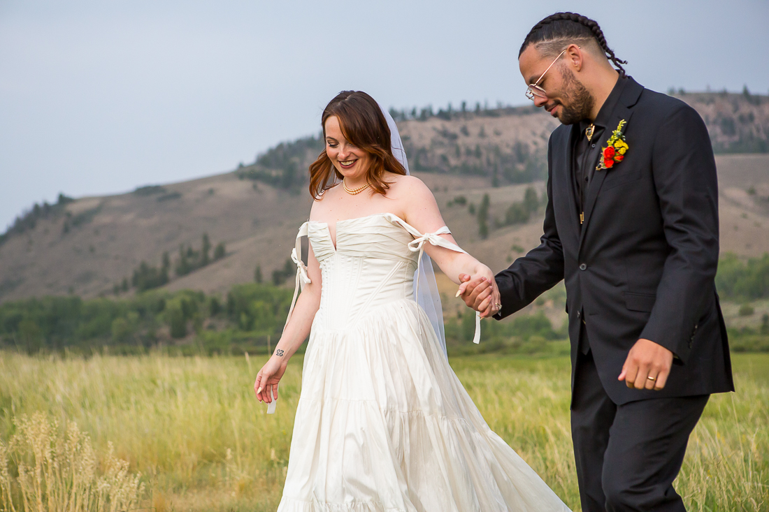 Bride and groom walk hand in hand during their Gunnison Colorado elopement.