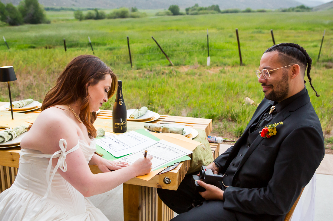 Couple signs marriage license at their airbnb